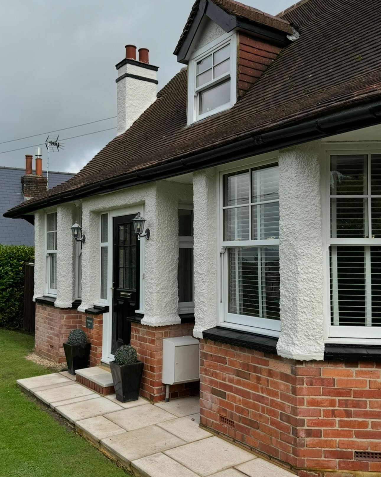 Restored white farmhouse exterior with black detailing