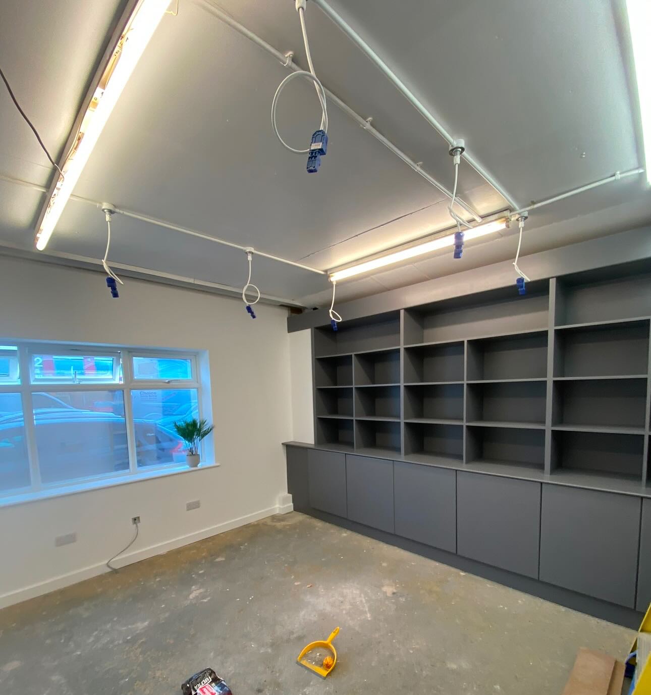Newly decorated office with grey fitted storage