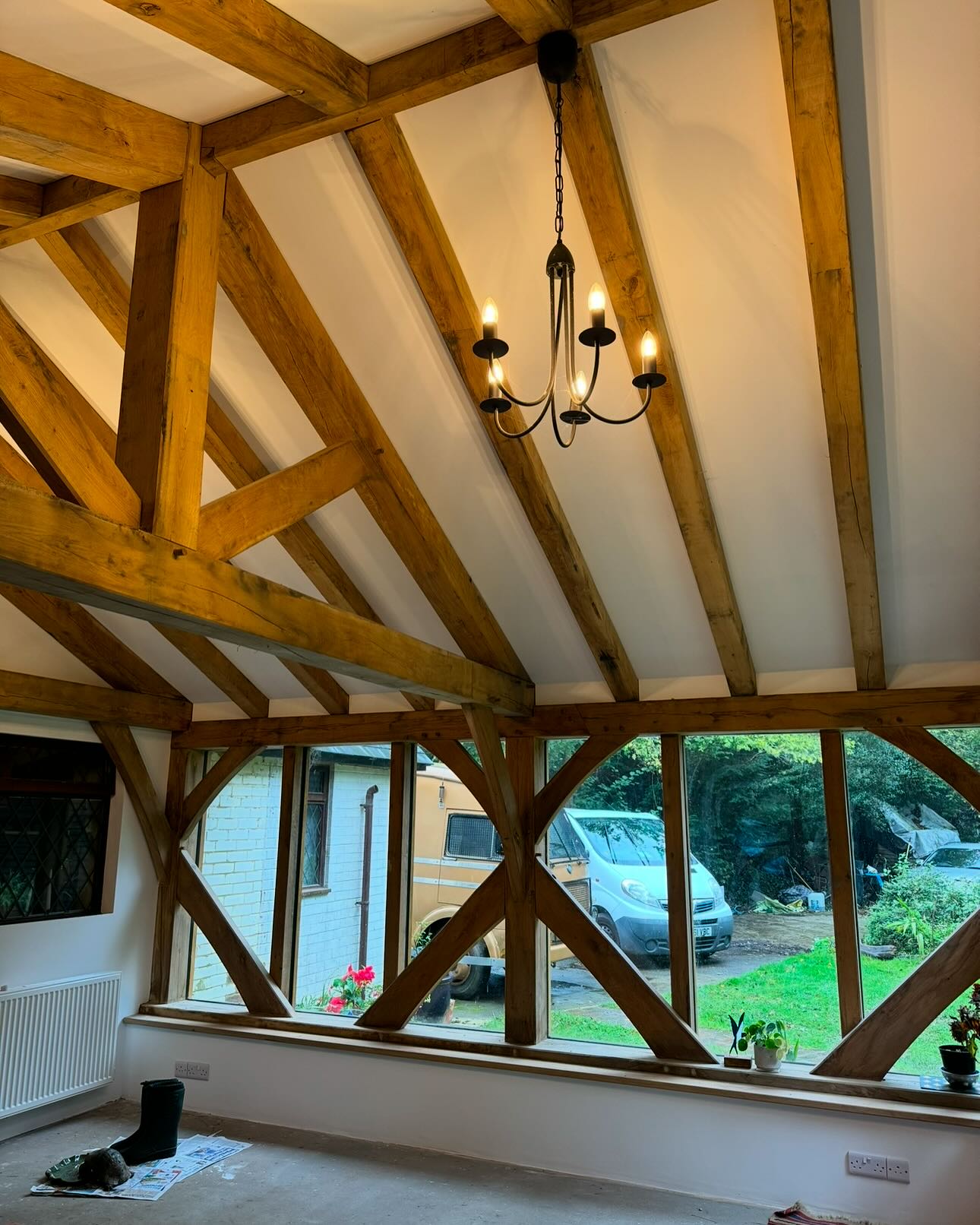 Finished room with exposed timber frame and white wall panels
